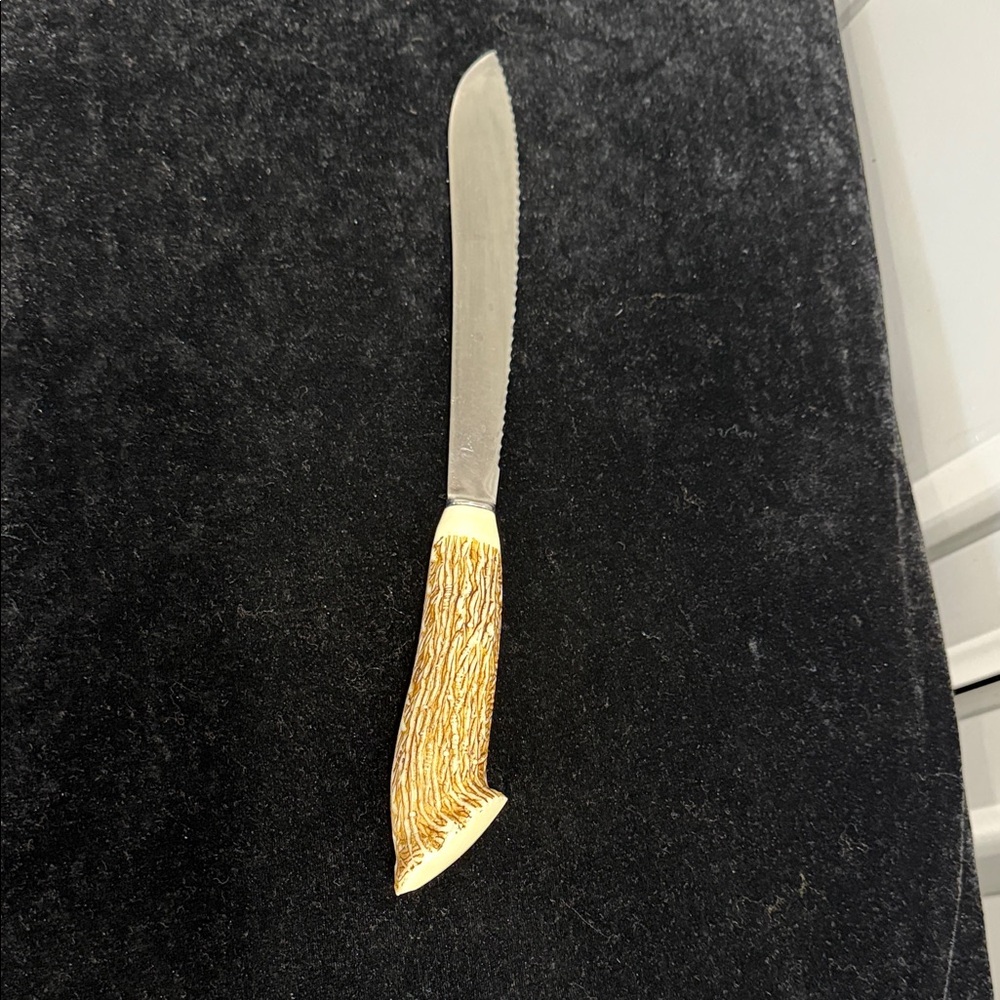 Vintage serrated, knife with faux antler plastic handle